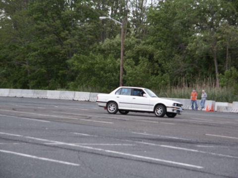 2001 Mercury Grand Marquis - A white sedan is seen on a racetrack during an event.