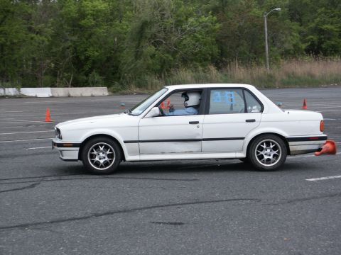 2001 Mercury Grand Marquis - A white sedan navigates a course marked by orange cones on a paved surface.