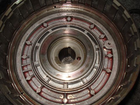 1984 Ford Bronco - This is a close-up view of a transmission torque converter, showing internal components and some red fluid.