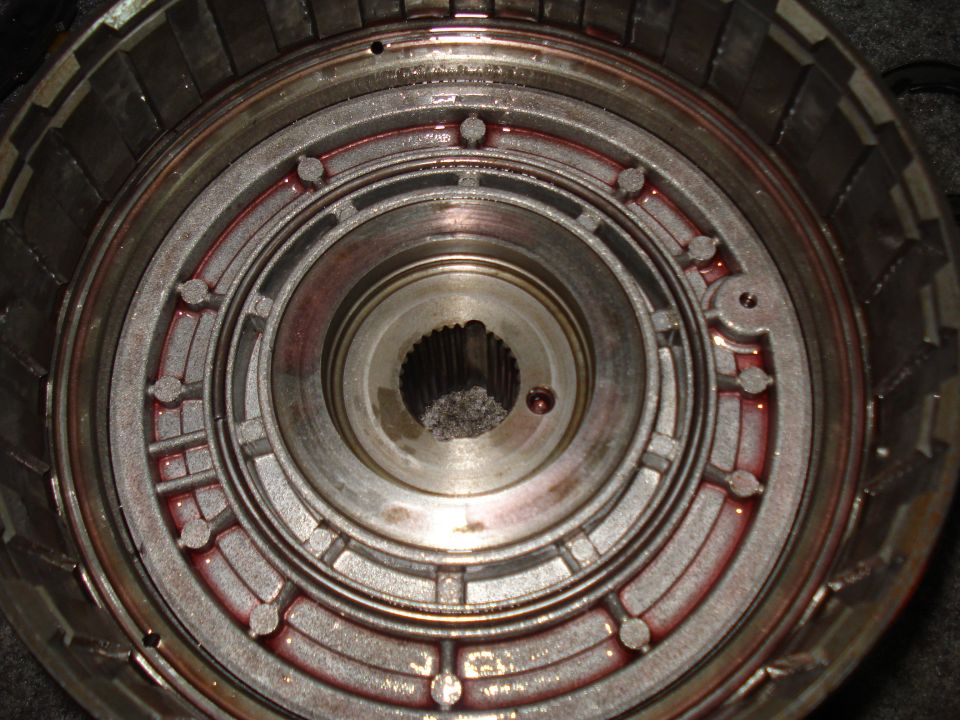 Close-up of a transmission torque converter with red fluid visible