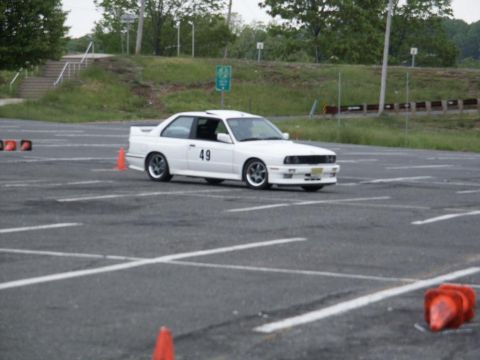 2001 Mercury Grand Marquis - A white BMW E30 M3 with racing number 49 navigates an autocross course.