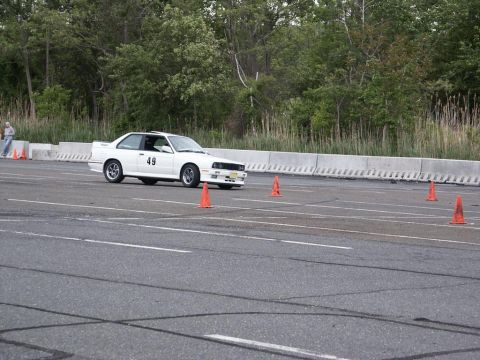2001 Mercury Grand Marquis - A white coupe navigates a course marked by orange cones on a paved track.