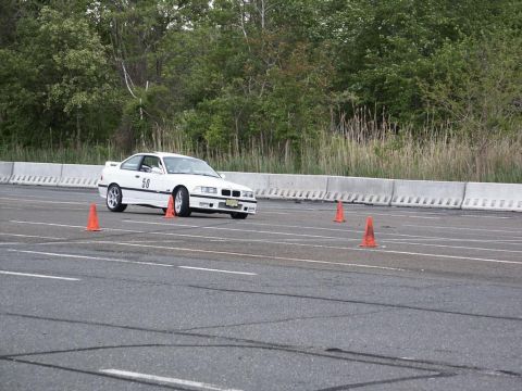 2001 Mercury Grand Marquis - A white coupe navigates a course marked by orange cones on a paved track.