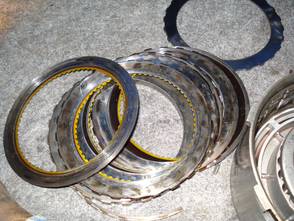 Stack of transmission clutch plates with yellow friction material