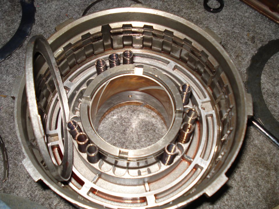 Disassembled transmission drum with springs and clutch plates