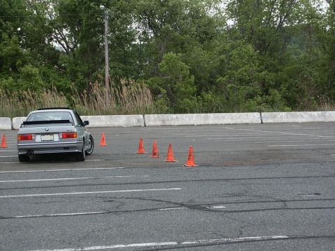 2001 Mercury Grand Marquis - Silver BMW E30 coupe at an autocross event with orange cones marking the course.
