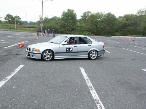 2001 Mercury Grand Marquis - A silver sedan, identified by the number 52 on its door, navigates an autocross course.