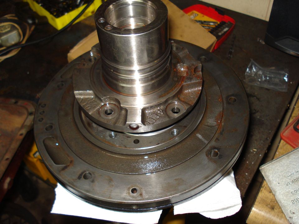 Transmission part on a workbench, showing metal components and rust