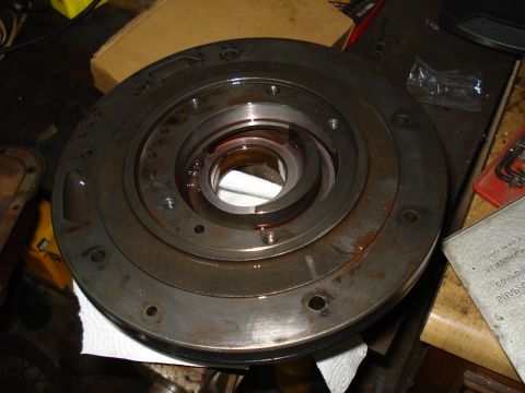 1984 Ford Bronco - A transmission torque converter is shown, with visible red fluid within its internal components.