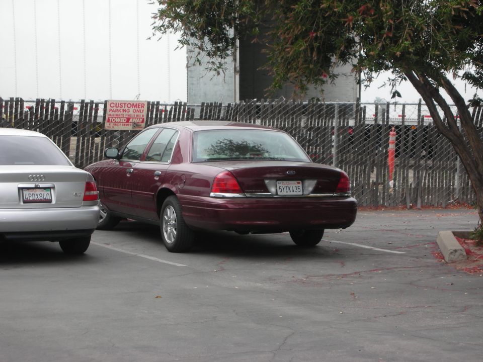 Maroon 1992 Ford Crown Victoria parked in a lot, rear view