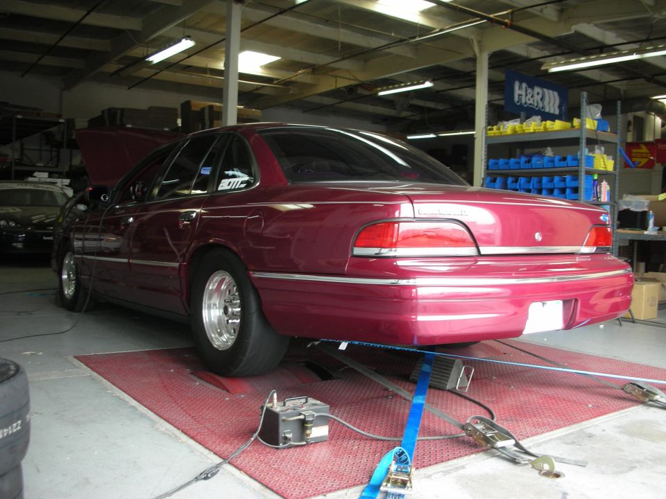 Maroon 1992 Ford Crown Victoria on a dynamometer, rear view