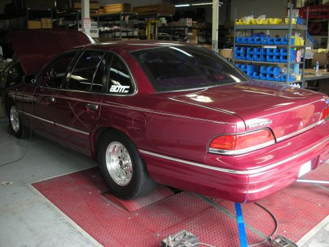1992 Ford Crown Victoria - Maroon sedan on a dynamometer, likely in a workshop or garage setting.