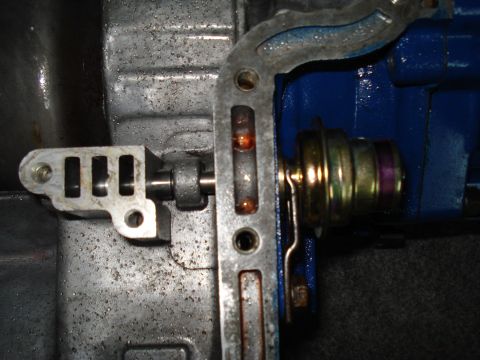 1984 Ford Bronco - Detail shot of internal transmission components, focusing on the shift linkage and a solenoid.