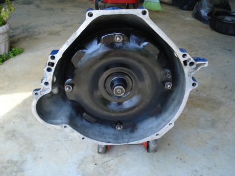 1984 Ford Bronco - Transmission part shown on dollies, with a visible torque converter inside the bell housing.