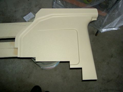 1967 Ford Ranchero - A beige interior trim piece is shown on a concrete floor, possibly for a vehicle restoration project.