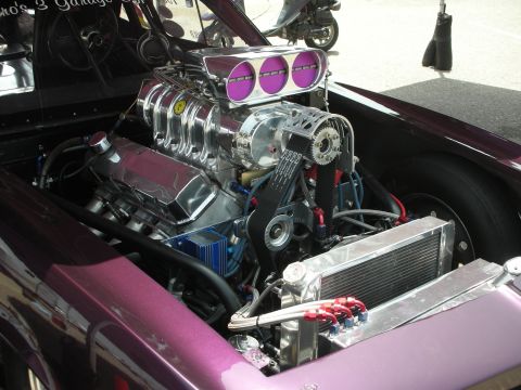 1998 Ford Crown Victoria - Customized engine bay of a purple car, a prominent supercharger and chrome components.