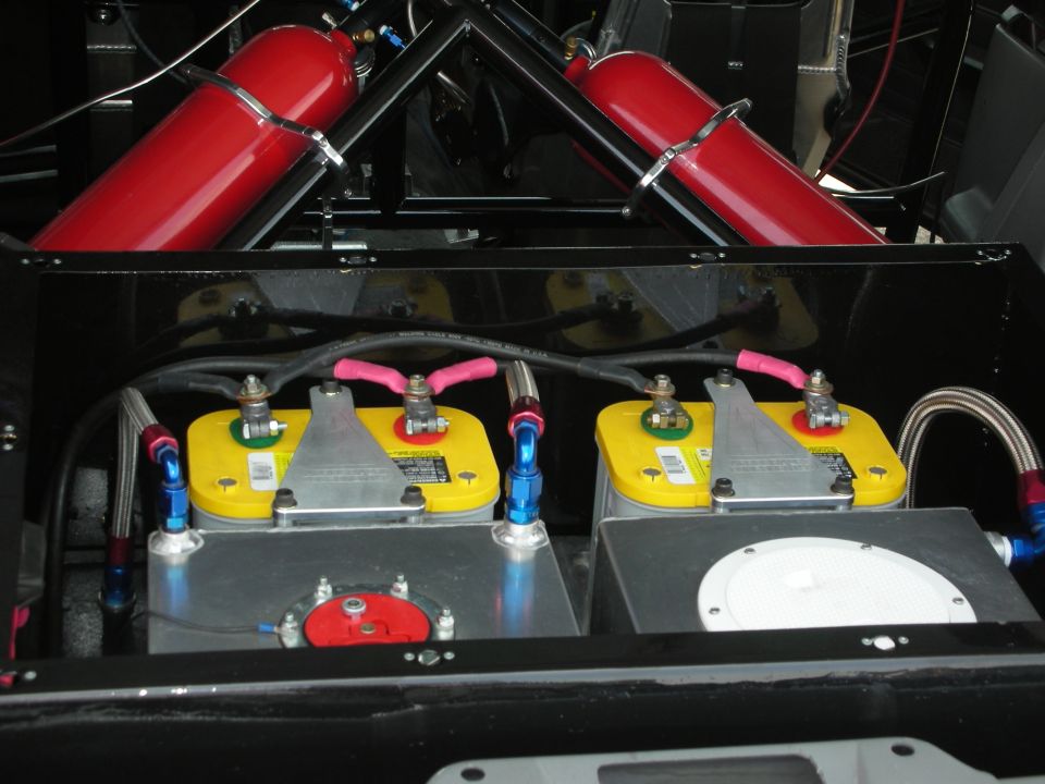 Two yellow Optima batteries with red and blue fittings, plus two red nitrous oxide tanks mounted above