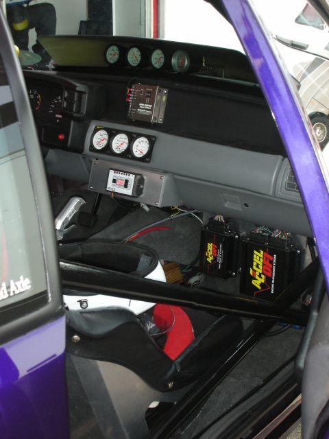 1998 Ford Crown Victoria - The interior of a modified race car shows numerous gauges and electronic control units.