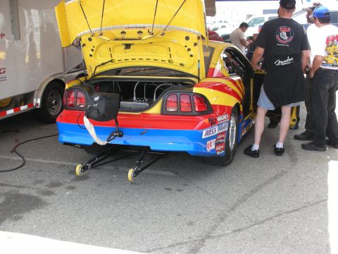1998 Ford Crown Victoria - Customized drag car with open trunk and hood, a vibrant paint scheme and racing modifications.