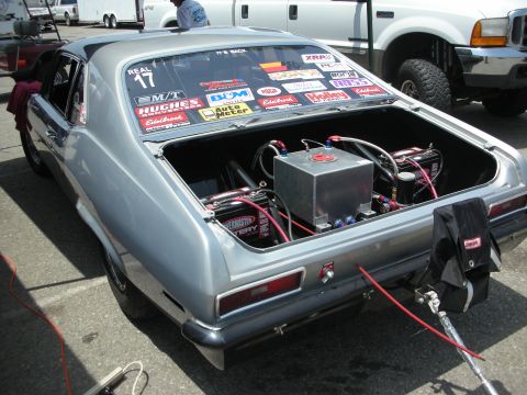 1998 Ford Crown Victoria - This silver coupe has racing modifications visible in its open trunk, including a fuel cell and batteries.