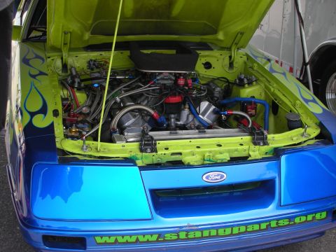 1998 Ford Crown Victoria - Customized engine bay a prominent "www.Stangparts.org" decal and flame graphics.