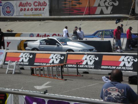 1998 Ford Crown Victoria - Drag racing cars are lined up on a track with K&N Filters signage visible.