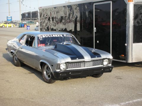 1998 Ford Crown Victoria - Modified 1970s Chevrolet Nova drag car with racing decals and a large hood scoop.