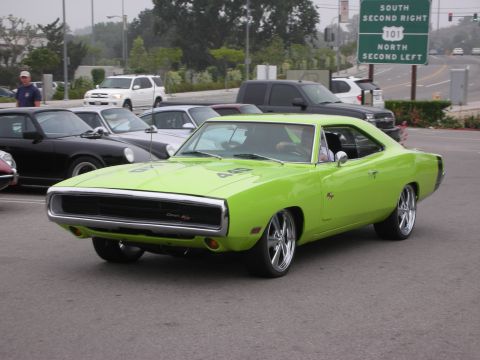 1998 Ford Crown Victoria - A lime green 1970 Dodge Charger R/T is seen at a coffee meet, distinguished by its iconic body style and R/T badging.
