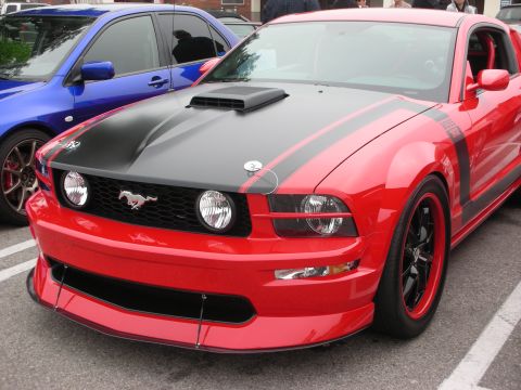 1998 Ford Crown Victoria - This red Ford Mustang, identified as a Boss 302, is parked next to a blue car at a coffee meet.