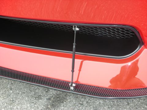 1998 Ford Crown Victoria - Front bumper detail showing a gas strut connected to the grille area.