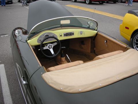 1998 Ford Crown Victoria - Interior of a vintage convertible sports car, with a yellow dashboard and tan upholstery.