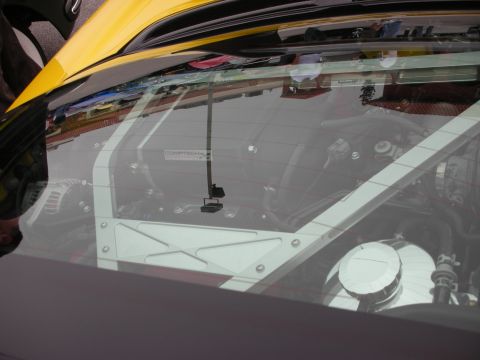 1998 Ford Crown Victoria - The interior of a modified car is visible through the rear window, a roll cage and engine components.