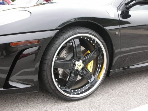 1998 Ford Crown Victoria - Black Ferrari wheel with yellow calipers and visible 'Ferrari' branding on the brake caliper.