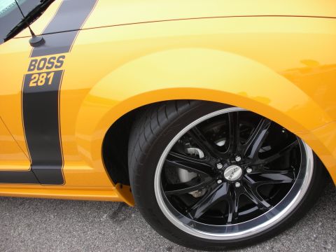 1998 Ford Crown Victoria - Close-up of a yellow car's front fender and wheel, a 'BOSS 281' graphic.