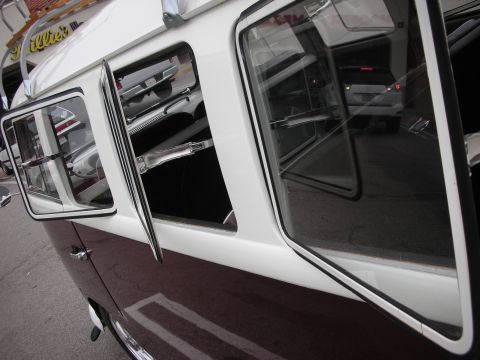 1998 Ford Crown Victoria - A classic Volkswagen Type 2 (Bus) parked, with reflections of other vehicles visible in its windows.