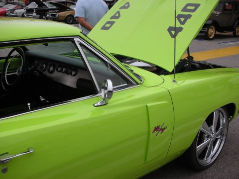 1998 Ford Crown Victoria - A bright lime green muscle car with its hood open, revealing "440" engine callouts and an "R/T" badge on the fender.