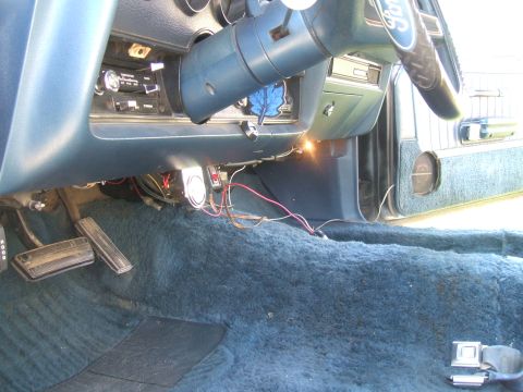 1974 Ford Ranchero - The interior of a 1974 Ford Ranchero shows blue carpeting, pedals, and dashboard details.