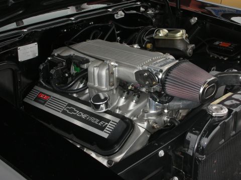 1998 Ford Crown Victoria - Close-up of a Chevrolet engine a prominent intake manifold, air filter, and "602" badging on the valve covers.