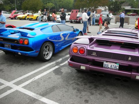 1998 Ford Crown Victoria - Blue Lamborghini Diablo SV and purple Lamborghini Diablo parked side-by-side at a car meet.