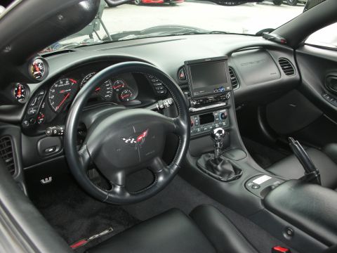 1998 Ford Crown Victoria - Interior view of a Corvette C5, showing the dashboard, steering wheel, and center console.