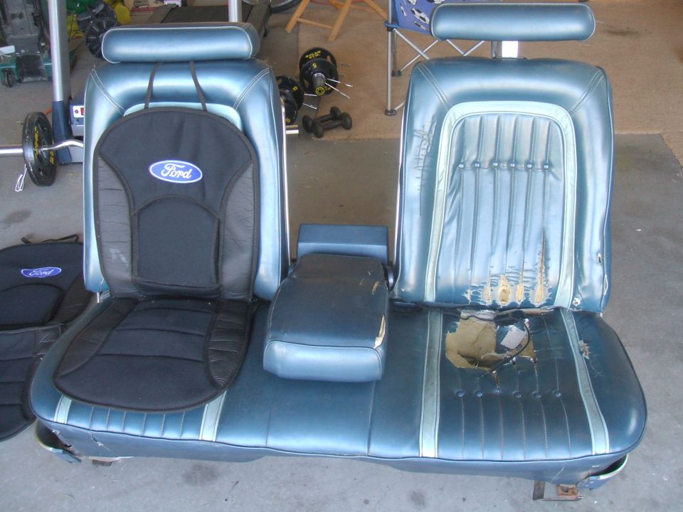 Blue vinyl car seats with a center console and Ford logos on seat covers