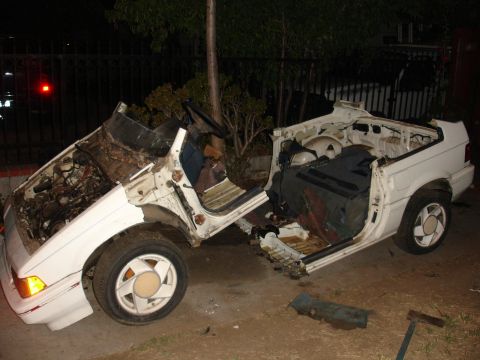 1993 Ford Taurus - This 1993 Ford Taurus convertible sustained severe damage, with its front end crushed and engine exposed.