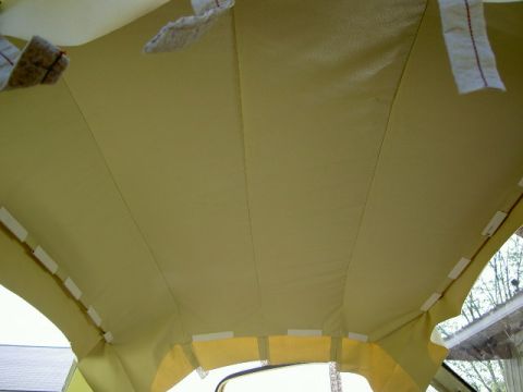 1967 Ford Ranchero - Interior view of a yellow headliner with visible stitching and clips holding it in place.