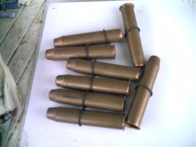 Several brass ammunition cartridges with black bands around them
