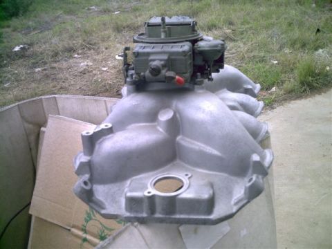 1964 Ford 427 - Engine intake manifold and carburetor assembly shown in an outdoor setting.