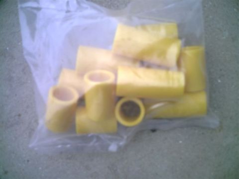 1964 Ford 427 - A bag contains several yellow rubber bushings, likely for automotive use.