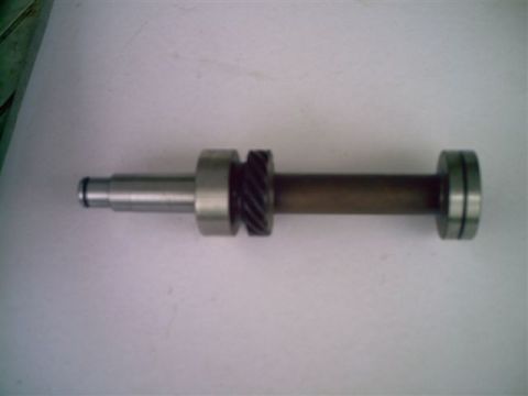 1964 Ford 427 - A metal shaft with gears and bearings is shown against a white background.