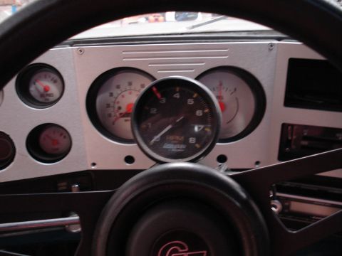 1979 Chevrolet C/K Pickup - A close-up view of the vehicle's dashboard displays aftermarket gauges and a steering wheel.