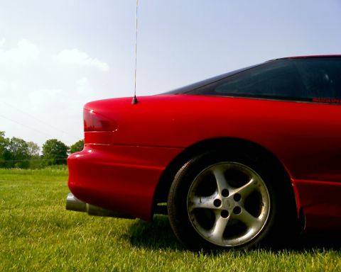 1993 Ford Probe - Rear view of a red 1993 Ford Probe with a five-spoke wheel and dual exhaust pipes.