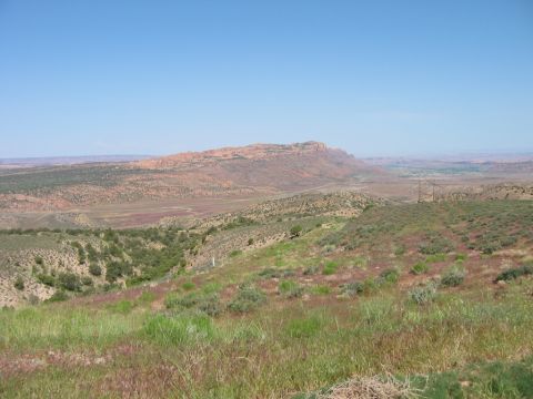 1997 Ford Ranger - Scenic desert view with mesas and sparse vegetation under a clear blue sky. Supermotors.net logo visible.